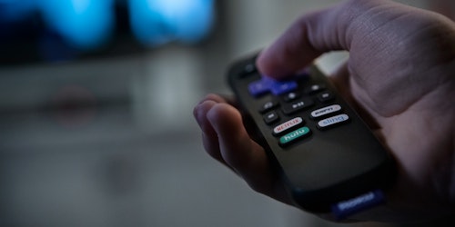 A consumer using a smart television to stream entertainment