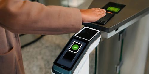 A customer holds their hand over an Amazon One scanner that uses a scan of their palm to process payment A customer holds their hand over an Amazon One scanner that uses a scan of their palm to process payment