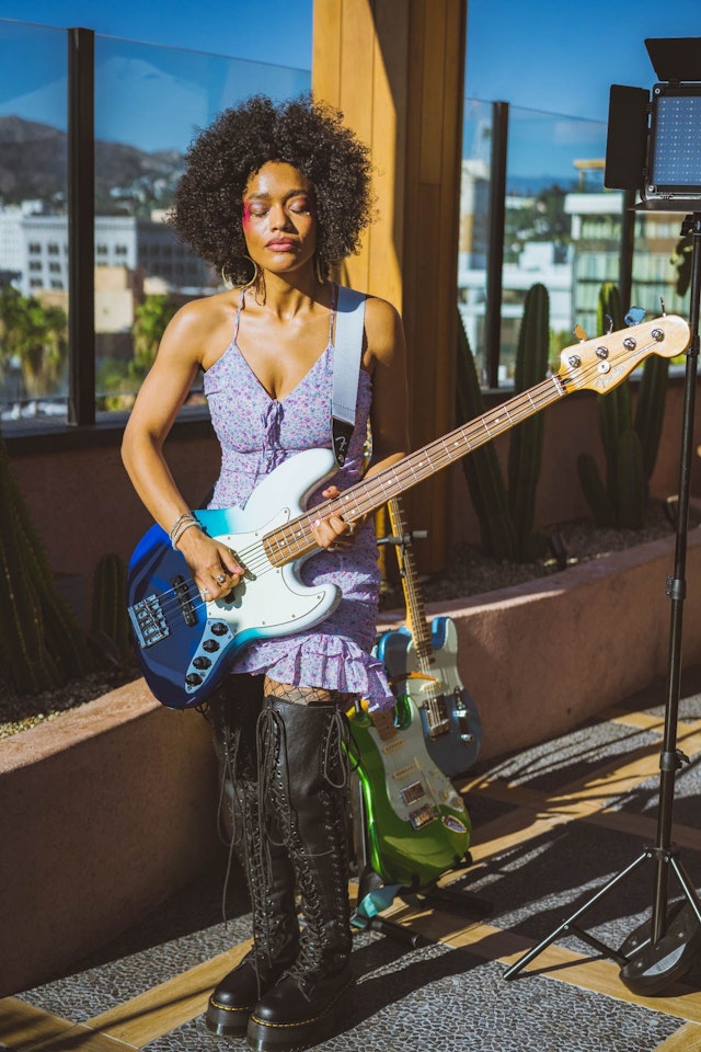 Musician April Kae, photographed using a bass from Fender's Player Plus range