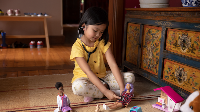 Girl playing with Barbie doll