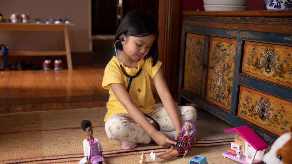 Girl playing with Barbie doll