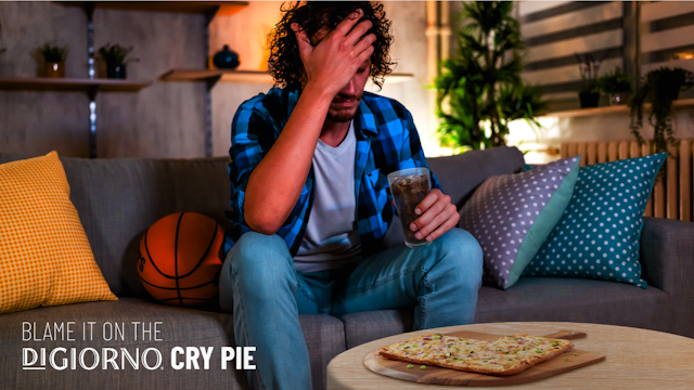 man crying next to a pizza