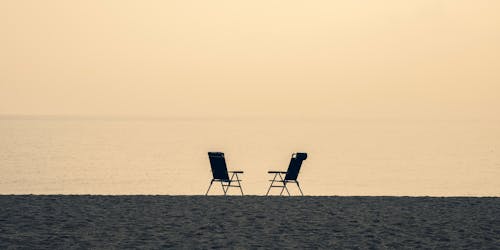 Two deck chairs on a beach Two deck chairs on a beach