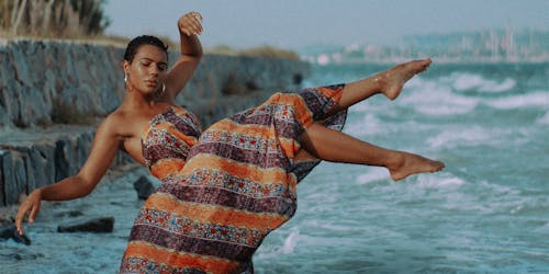 Woman in dress hovering over ocean Woman in dress hovering over ocean