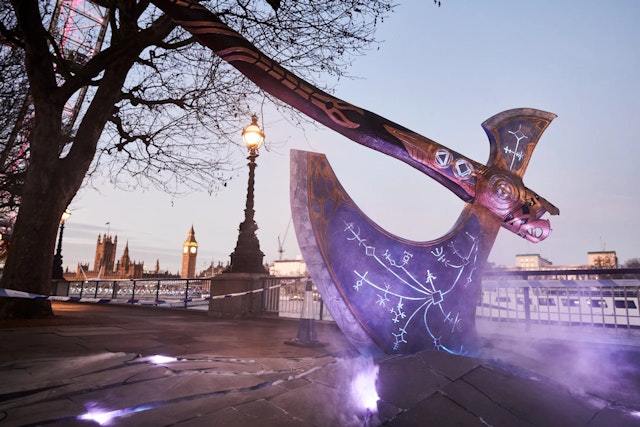 An enormous Leviathan Axe from PS5 game Kratos in a London street with Big Ben visable in the background