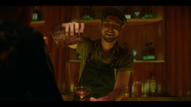 Man pours drink in bar Man pours drink in bar