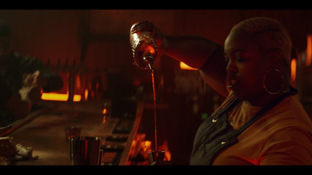 Woman pouring bourbon drink in bar Woman pouring bourbon drink in bar
