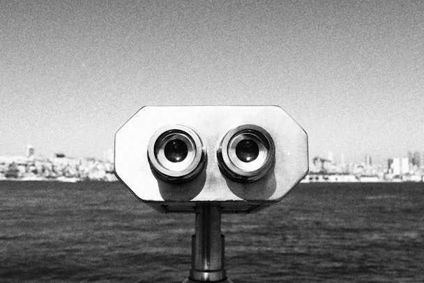 A black-and-white photograph of a binocular-style viewfinder