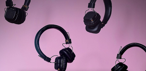 Headphones falling against a purple background representing the different forms of audio content