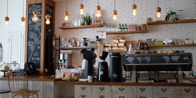 Photograph of a coffee shop counter with coffee machine and menu