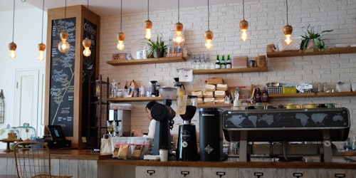 Photograph of a coffee shop counter with coffee machine and menu