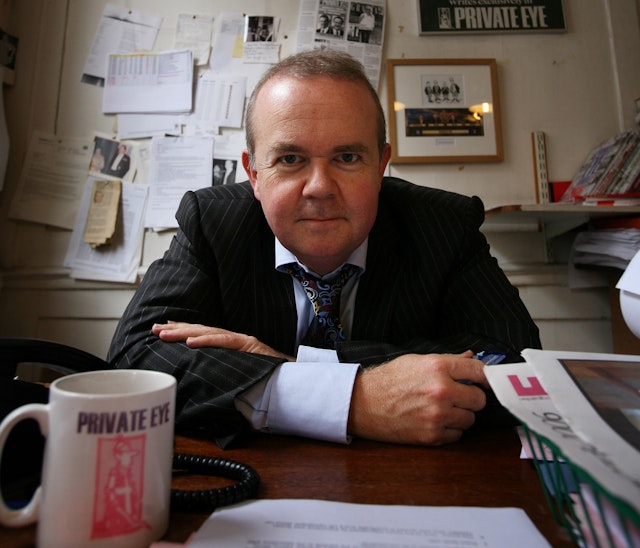 Hislop at his desk in the Private Eye offices on Carlisle Street