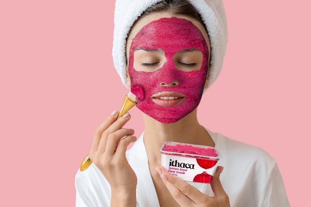 Woman putting on face mask
