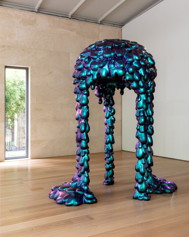 Abstract blue-green sculpture that appears to be melting