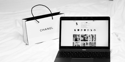 A Chanel shopping bag and a laptop