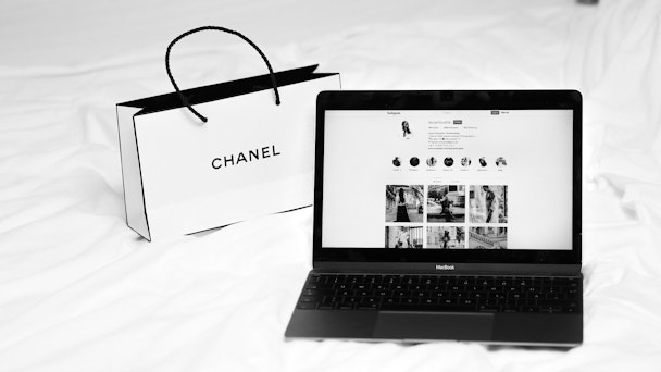 A Chanel shopping bag and a laptop