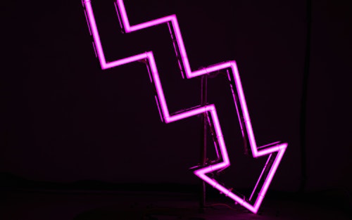 A neon arrow pointing downward