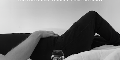Black and white closeup of a man lying down holding his stomach with a tub of Tums next to him and the words 'The tortured tummies department' 