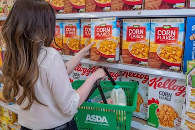 A shopper selecting Asda's own cereal over branded Kellogg's Corn Flakes