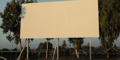 A blank billboard in front of a blue sky