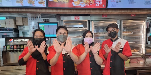 kfc singapore staff participating in the 'let kindness fly' campaign