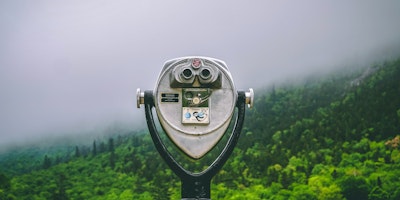 A tower viewer in front of a hilly landscape