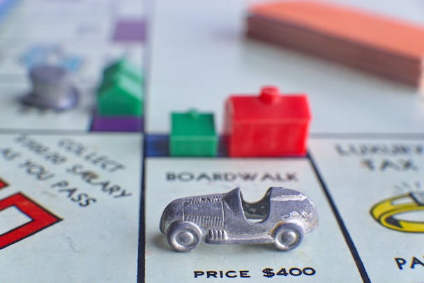 A car parked on a Monopoly board A car parked on a Monopoly board