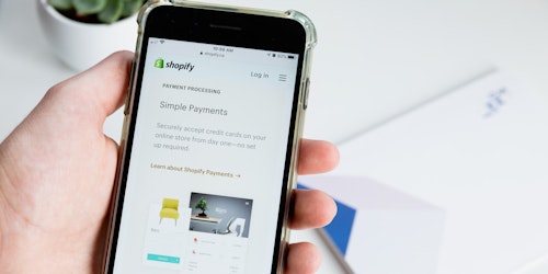 A user looking at Shopify on their phone