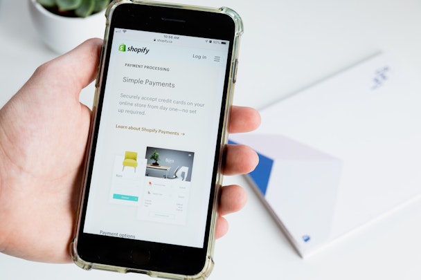 A user looking at Shopify on their phone