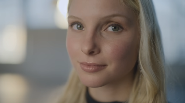 A still from Dove and Ogilvy's 'Cost of Beauty' campaign showing a closeup image of a blonde woman's face