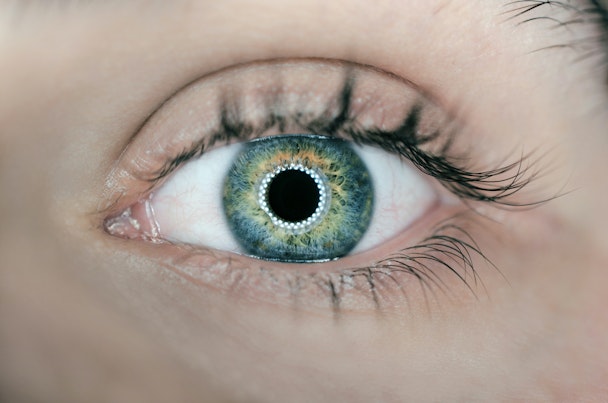 A close of up an eye, lit by an influencer light