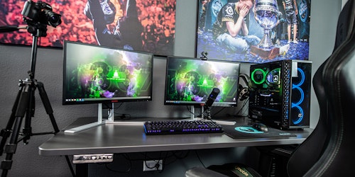 A gaming setup, with esports posters and multiple screens plus streaming equipment