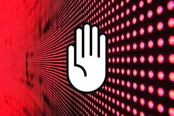 A white hand signifying stop over a digital stream of information