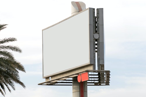 An empty billboard against the background of a blue sky