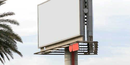 An empty billboard against the background of a blue sky