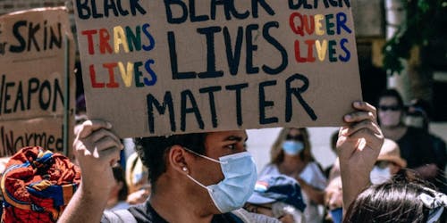 Man at protest holds Black Lives Matter placard Man at protest holds Black Lives Matter placard