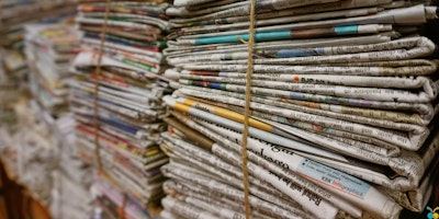 tall stacks of newspapers