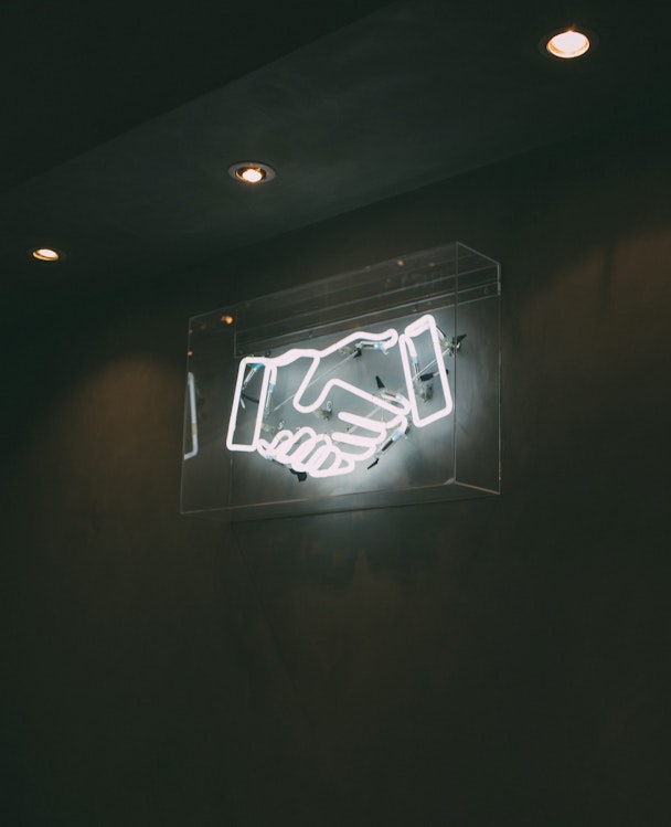 human hand neon signage on wall