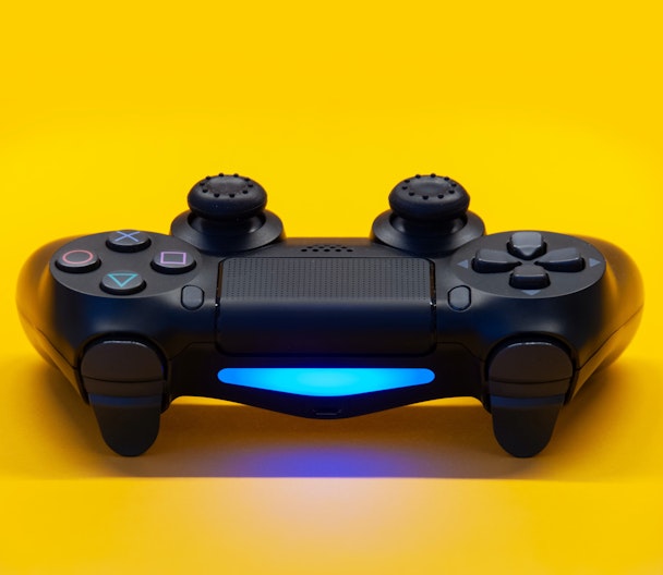play station controller on yellow background