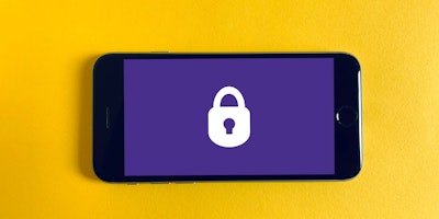 iphone screen with a lock image, sitting on a yellow bakground