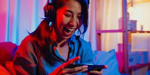 Asian girl gaming on her phone