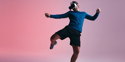 Sporty young man kicking a virtual ball in the metaverse