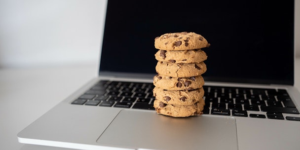 Stack of choc chip cookies on a laptop