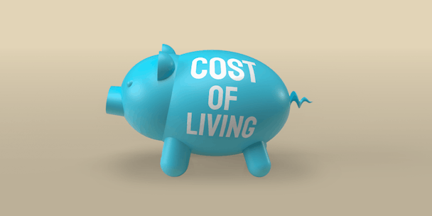 Blue Piggy bank with cost of living across the side