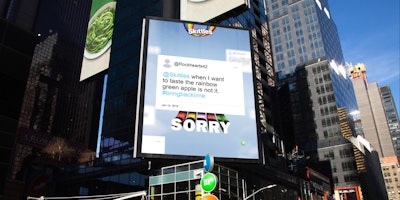 A Times Square billboard with a Skitttles ad apologizing to angry fans 