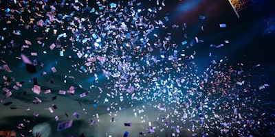 Photograph of people partying with confetti
