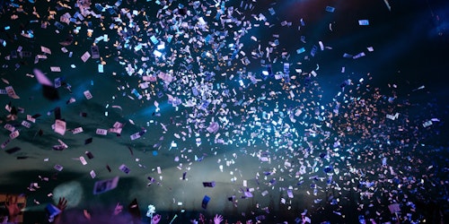Photograph of people partying with confetti