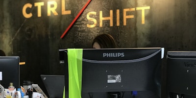 Green 'muscle stretching' scarf hangs over the back of a computer monitor screen.