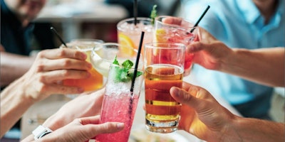 Five hands hold colourful drinks together to say "Cheers!"