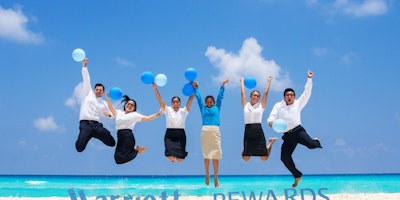 marriot loyalty shot of staff jumping in the air.